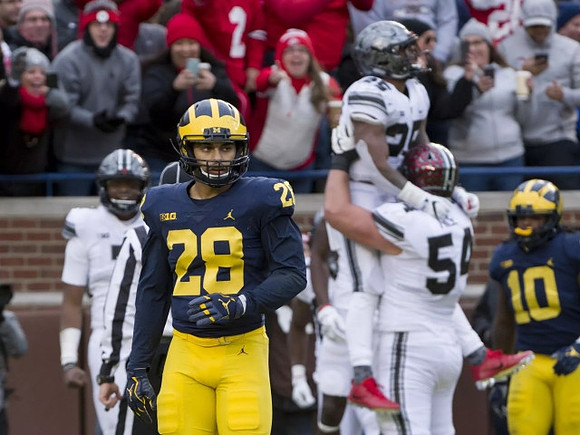 Brandon Watson (28) and Devin Bush (10)