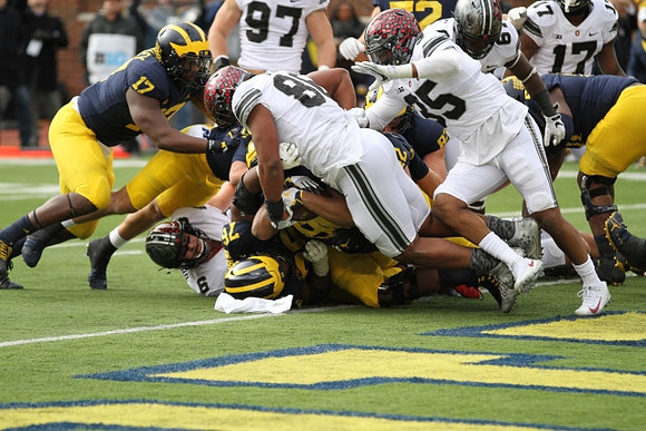 Tyrone Wheatley Jr. (17), Juwann Bushell-Beatty (76), Khalid Hill (80), Mason Cole (52), and Zach Gentry (83)
