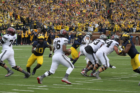 Devin Bush (10), Josh Metellus (14), and Rashan Gary (3)