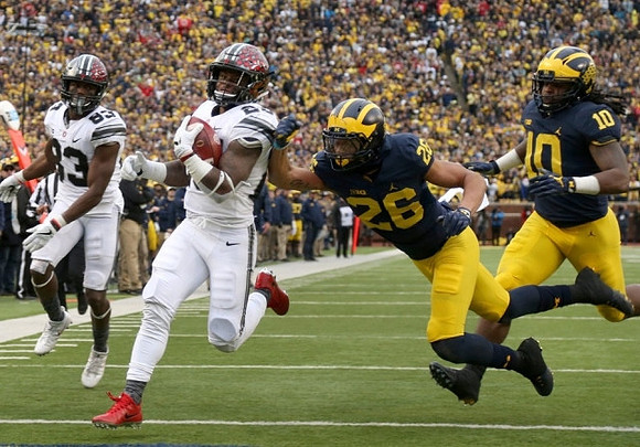 J'Marick Woods (26) and Devin Bush (10)