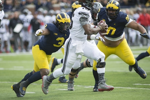 Rashan Gary (3) and Bryan Mone (90)