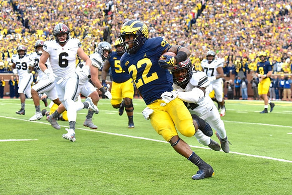 Cesar Ruiz (51), Karan Higdon (22), and John O'Korn (8)