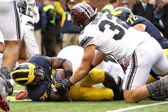 Karan Higdon (22) and Stephen Spanellis (72)