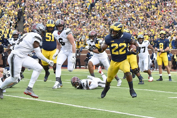 Cesar Ruiz (51), Karan Higdon (22), and John O'Korn (8)