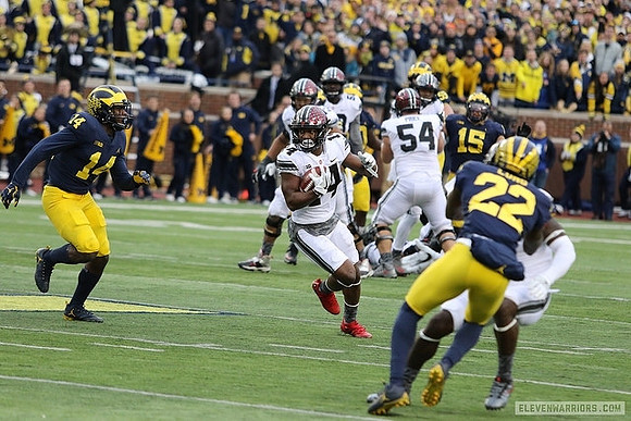 Josh Metellus (14), David Long (22), and Chase Winovich (15)