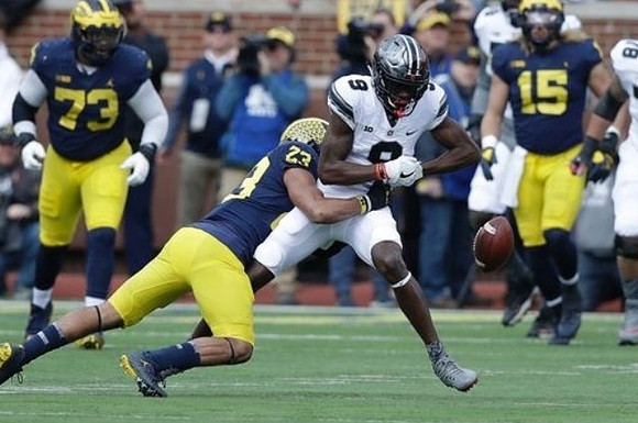 Maurice Hurst (73), Tyree Kinnel (23), and Chase Winovich (15)