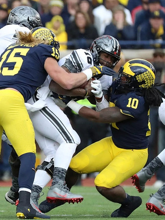 Chase Winovich (15) and Devin Bush (10)