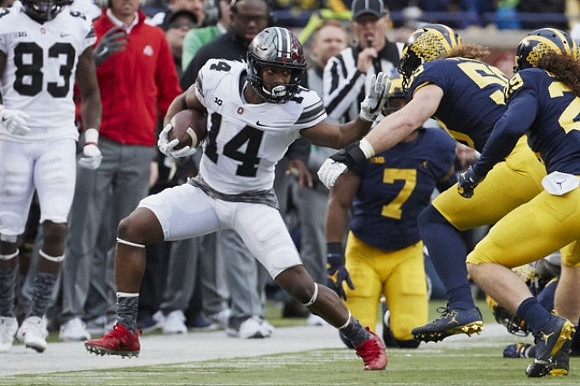 Khaleke Hudson (7), Noah Furbush (59), and Jordan Glasgow (29)