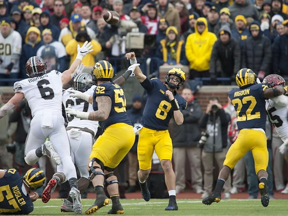 Patrick Kugler (57), Mason Cole (52), John O'Korn (8), and Karan Higdon (22)