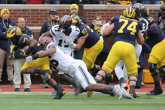 Karan Higdon (22), Patrick Kugler (57), Ben Bredeson (74), and Cesar Ruiz (51)