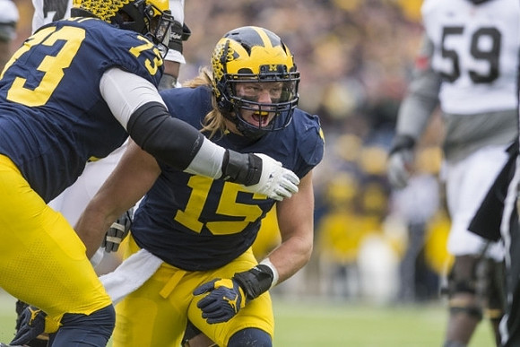 Maurice Hurst (73) and Chase Winovich (15)