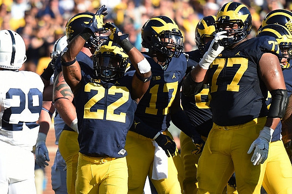 Tyrone Wheatley Jr. (17), Grant Newsome (77), and Rashan Gary (3)