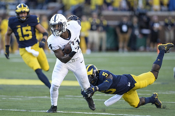 Chase Winovich (15) and Jabrill Peppers (5)