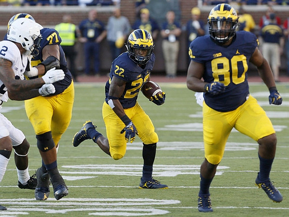 Grant Newsome (77), Karan Higdon (22), and Khalid Hill (80)