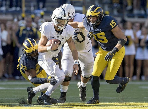 Maurice Hurst (73) and Chase Winovich (15)
