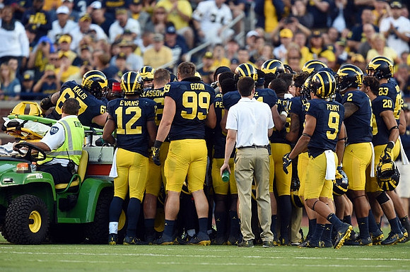 Jeremy Clark (34) and Michigan Team