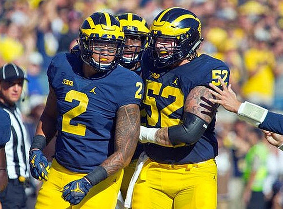 Devin Asiasi (2) and Mason Cole (52)