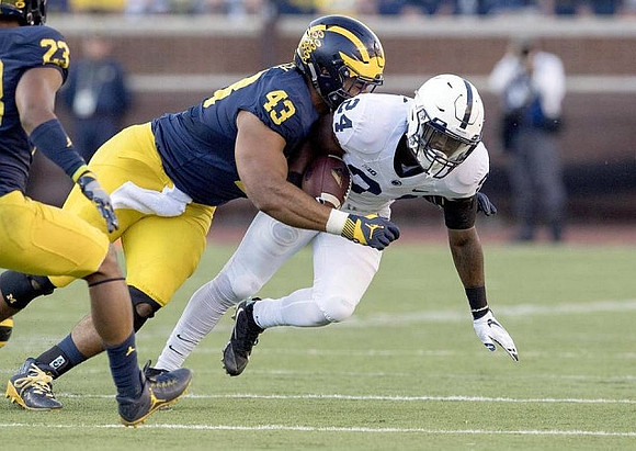 Tyree Kinnel (23) and Chris Wormley (43)