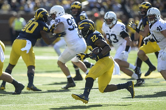 Khalid Hill (80), Karan Higdon (22), and Kyle Kalis (67)