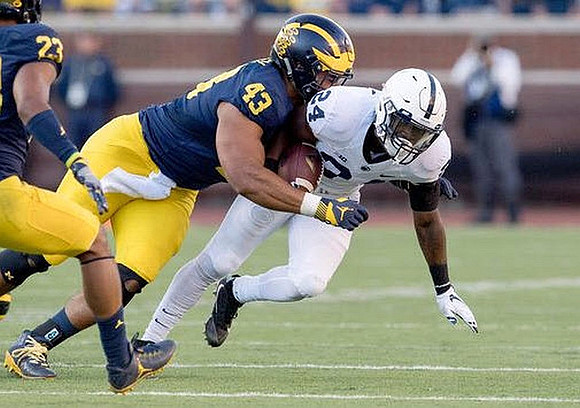 Tyree Kinnel (23) and Chris Wormley (43)