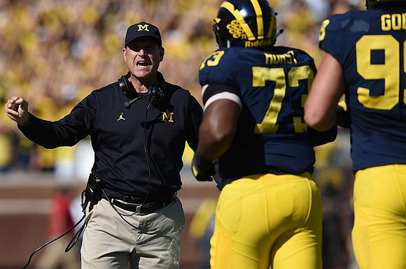 Jim Harbaugh, Maurice Hurst (73), and Matthew Godin (99)