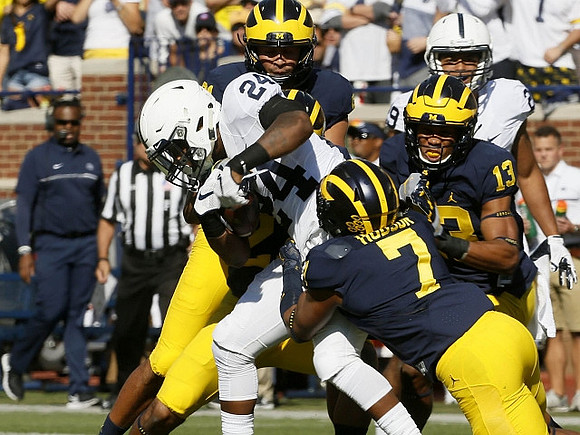 Khaleke Hudson (7) and Josh Metellus (13)