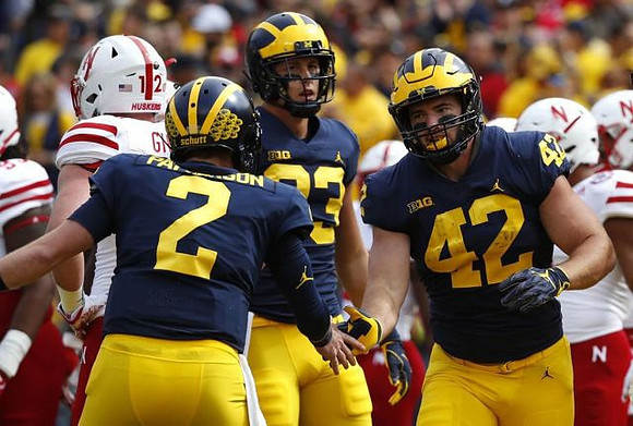 Shea Patterson (2), Zach Gentry (83), and Ben Mason (42)