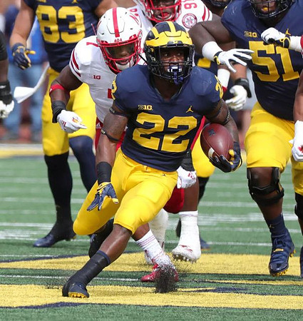 Zach Gentry (83), Karan Higdon (22), and Cesar Ruiz (51)