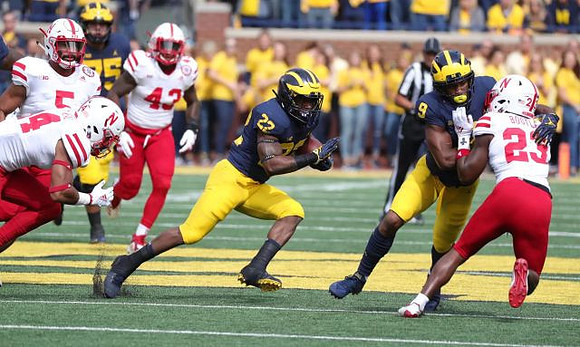 Jon Runyan Jr. (75), Karan Higdon (22), and Donovan Peoples-Jones (9)
