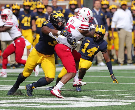 Rashan Gary (3) and Josh Metellus (14)