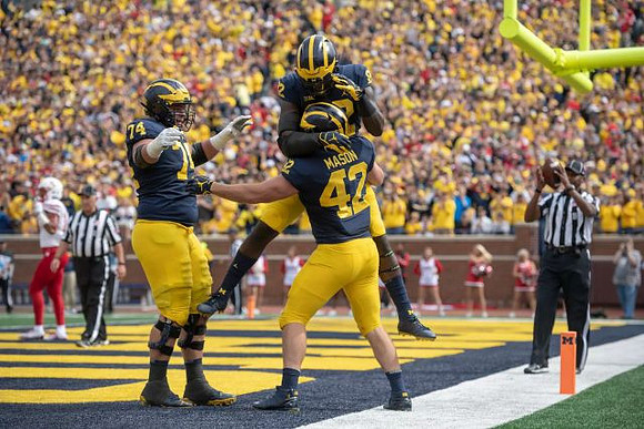 Ben Bredeson (74), Ben Mason (42), and Karan Higdon (22)
