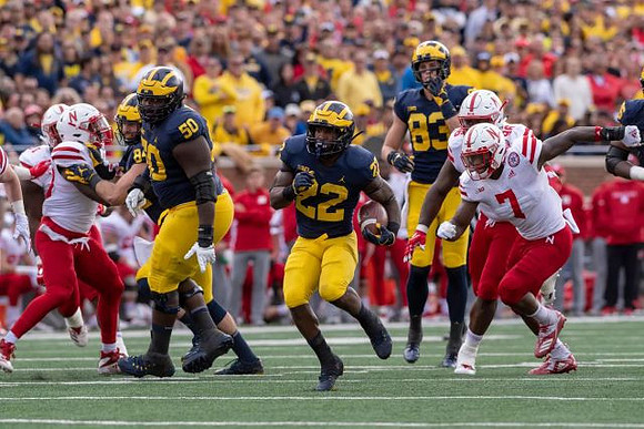Michael Onwenu (50), Karan Higdon (22), and Zach Gentry (83)