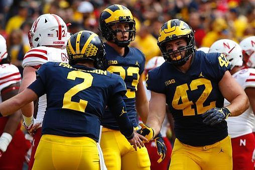 Shea Patterson (2), Zach Gentry (83), and Ben Mason (42)