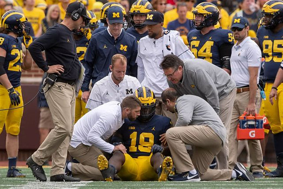 Kwity Paye (19) and Jim Harbaugh