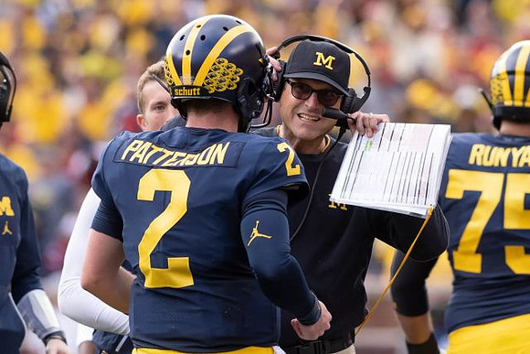 Shea Patterson (2), Jim Harbaugh, and Jon Runyan Jr. (75)