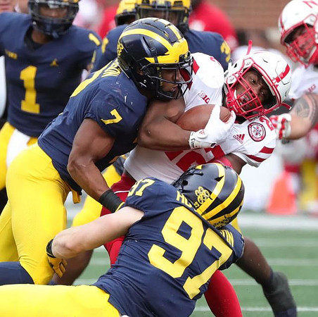Ambry Thomas (1), Khaleke Hudson (7), and Aidan Hutchinson (97)