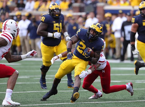 Cesar Ruiz (51), Karan Higdon (22), and Jon Runyan Jr. (75)