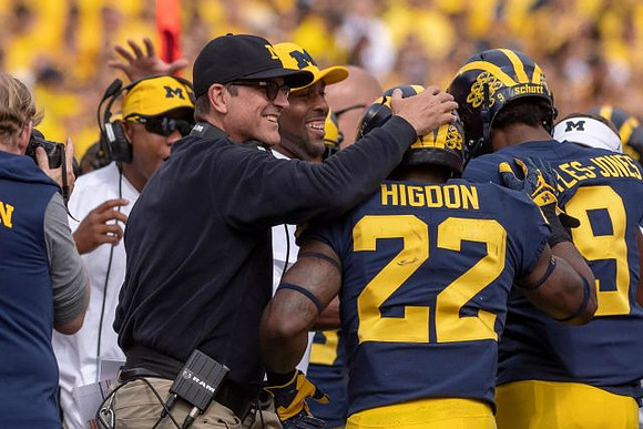 Jim Harbaugh, Karan Higdon (22), and Donovan Peoples-Jones (9)