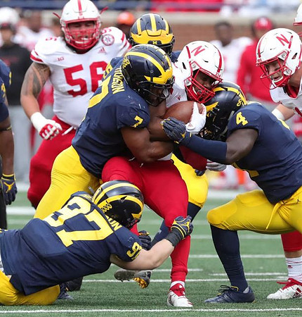 Aidan Hutchinson (97), Khaleke Hudson (7), and Reuben Jones (4)