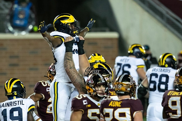Mike Sainristil (19), Hassan Haskins (25), Ryan Hayes (76), and Andrew Vastardis (68)