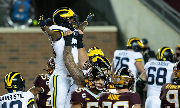 Mike Sainristil (19), Hassan Haskins (25), Ryan Hayes (76), and Andrew Vastardis (68)