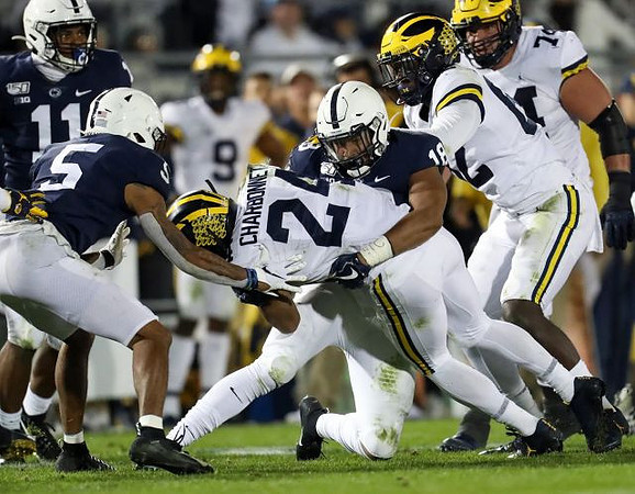 Zach Charbonnet (24), Nick Eubanks (82), and Ben Bredeson (74)
