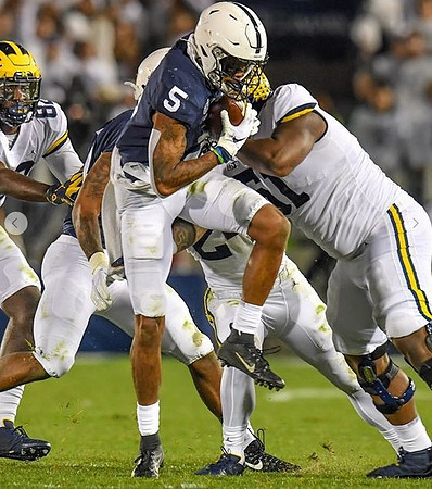 Nick Eubanks (82), Zach Charbonnet (24), and Cesar Ruiz (51)