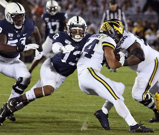 Zach Charbonnet (24) and Michael Onwenu (50)