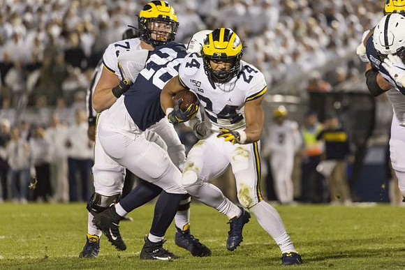 Jalen Mayfield (73) and Zach Charbonnet (24)