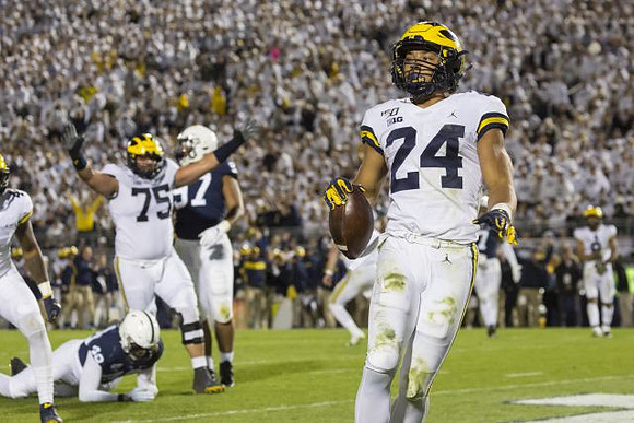 Nico Collins (4), Jon Runyan Jr. (75), and Zach Charbonnet (24)