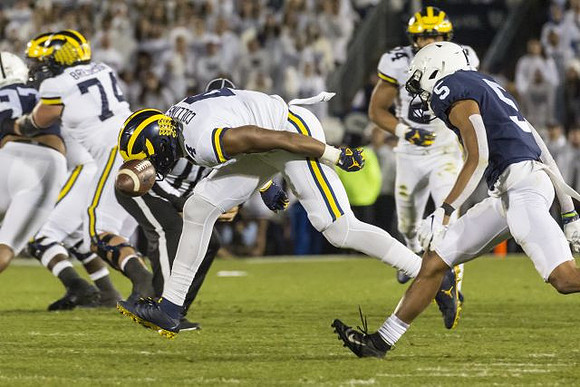 Ben Bredeson (74), Nico Collins (4), and Zach Charbonnet (24)