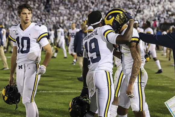 Dylan McCaffrey (10), Mike Sainristil (19), and Ronnie Bell (8)