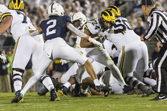 Jon Runyan Jr. (75), Zach Charbonnet (24), and Michael Onwenu (50)