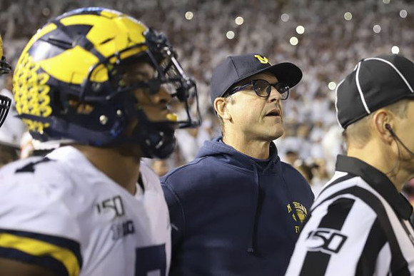 Khaleke Hudson (7) and Jim Harbaugh